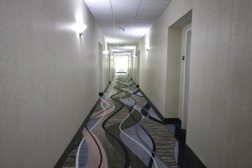 a hallway with a mosaic floor in a building at MainStay Suites Madison Airport in Madison