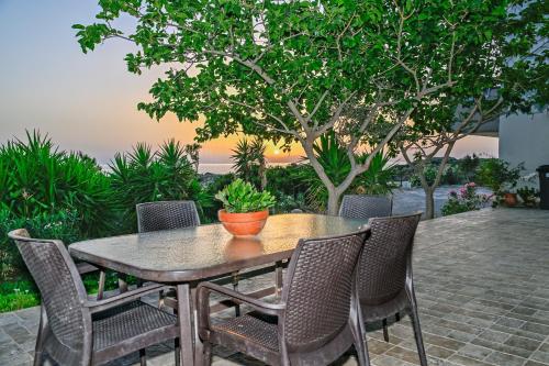 a wooden table and chairs on a patio at Panorama in Elafonisi