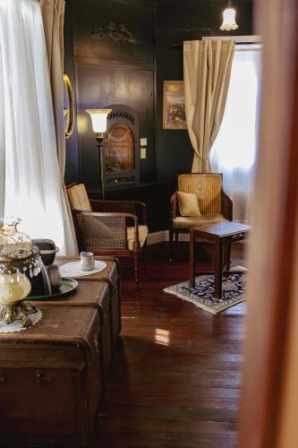 a living room with chairs and a table and a window at Weaverville Hotel in Weaverville