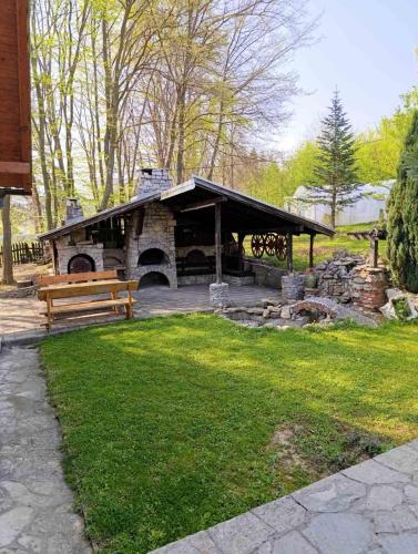 a gazebo with a bench in a park at Villa Ema in Sarajevo