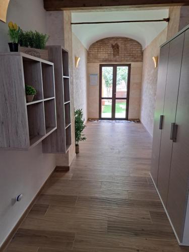 a hallway in a building with wooden floors and a door at Struttura Monte Olimpo in Porto Torres