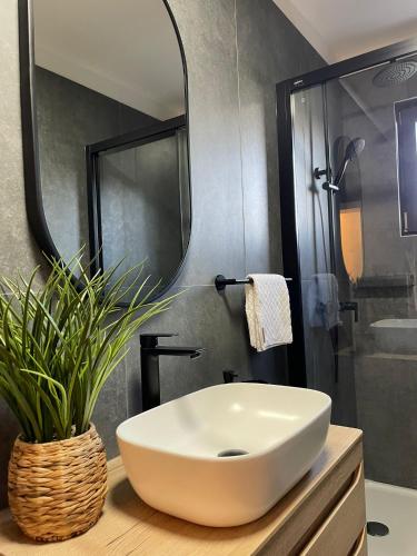 a bathroom with a white sink and a mirror at Apartmani Natali in Orebić