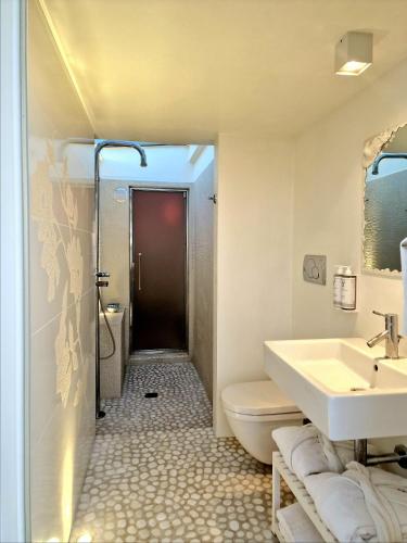 a bathroom with a sink and a toilet and a shower at Luxor Beach Boutique Hotel Cattolica in Cattolica