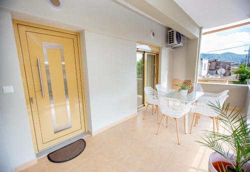 a dining room with a table and chairs at Fay's Apartment in Nea Vrasna