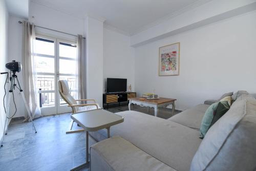 a living room with a couch and a table at Coo-Coo Place in Kalamata