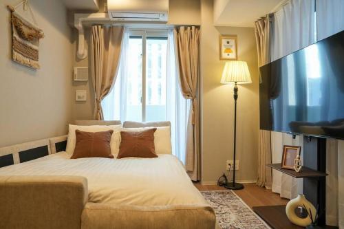 a bedroom with a bed and a large window at Brand New Open ROOM MD 401 Max 6pax in Sapporo