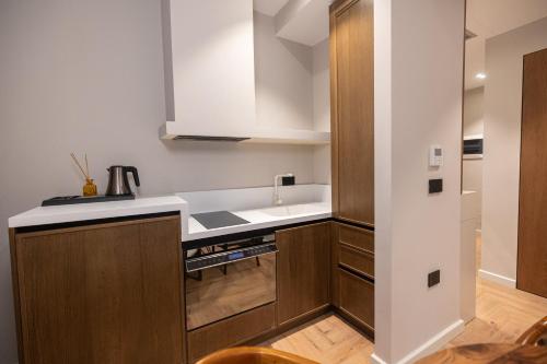 a kitchen with a sink and a stove top oven at Diora'S Hotel and Apartments in Vlorë