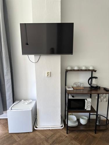 a flat screen tv on a wall above a microwave at Pension Moravia in Olomouc