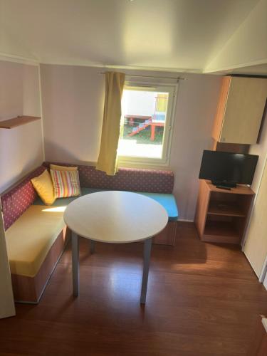 a small room with a table and a couch at Camping LagoMar in Muxia
