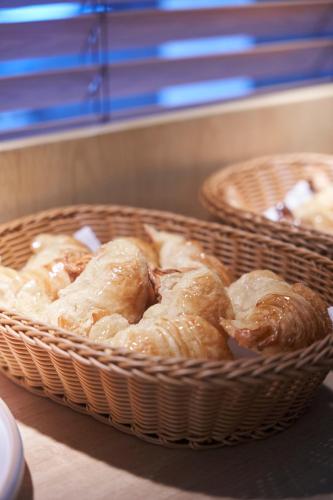 two baskets filled with donuts sitting on a counter at Bromelia Hotel Boutique in Buenos Aires