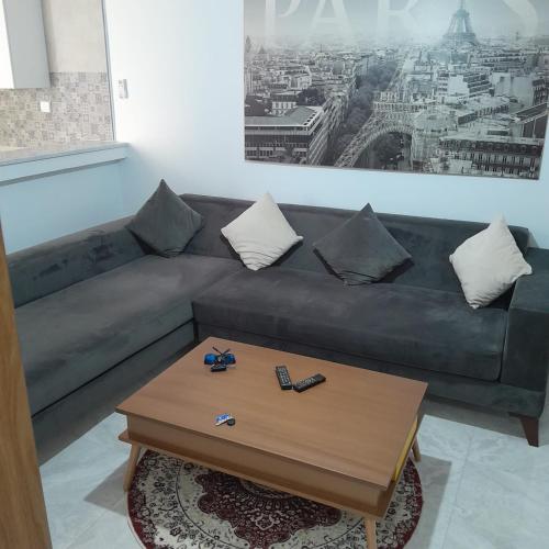 a living room with a couch and a coffee table at My studio in Al Matlīn