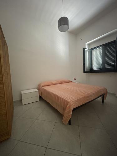 a bedroom with a large bed in a room at Appartamento a 10 metri dal mare, Porto Cesareo in Porto Cesareo