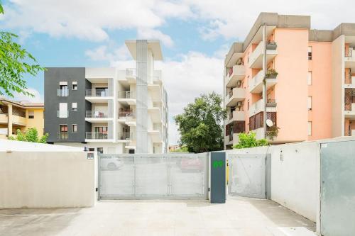 a fence in front of a apartment building at Holiday Camelia in Pirri