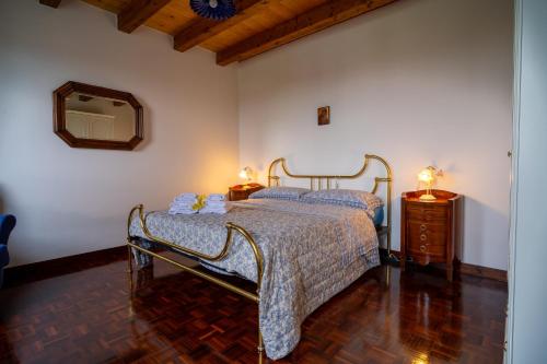 a bedroom with a bed and a dresser and a mirror at B&B da Monsignore in Crespano del Grappa