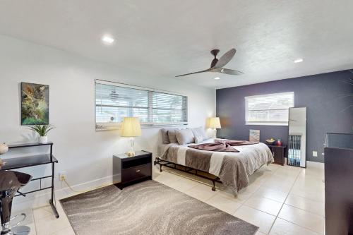 a bedroom with a bed and a ceiling fan at Modern Getaway in Cape Coral