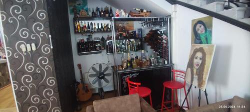 a room with a bar with two red stools at Kuki dom Ganja in Bagbanlar
