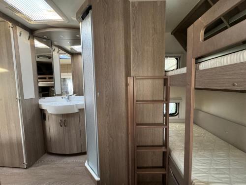 a bathroom with a sink and a bunk bed at Przyczepa 2022 MOLO SURF in Jastarnia