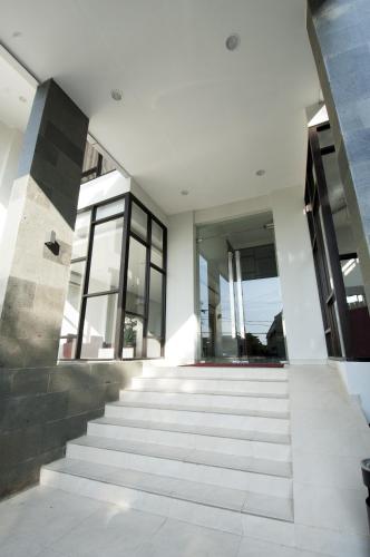 a staircase leading up to a building with windows at Genio Hotel Manado in Manado