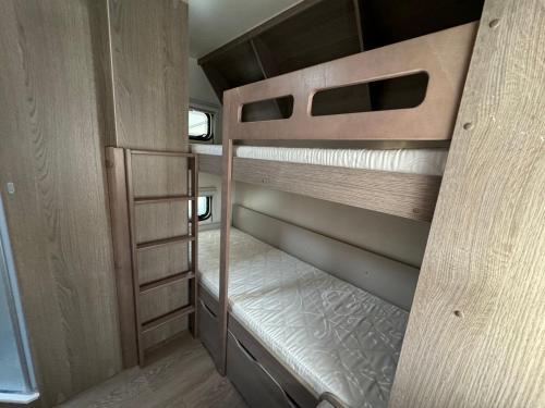 a couple of bunk beds in a small room at Przyczepa 2022 MOLO SURF in Jastarnia