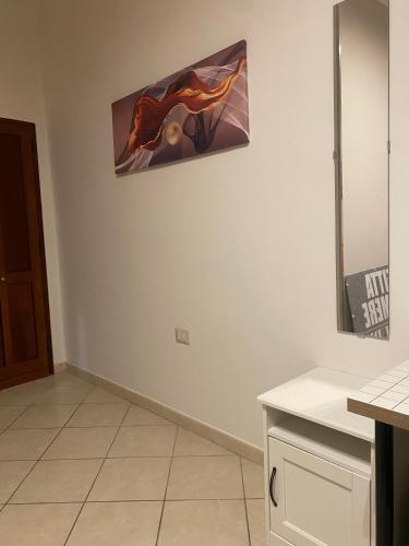 a kitchen with a painting hanging on the wall at Affittacamere Claury in Mercato San Severino