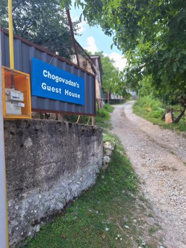 a sign for a guest house on the side of a road at Chogovadze's Guest House in K'vemo Zhoshkha