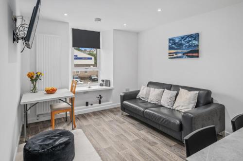 a living room with a couch and a table at Cosy & Comfortable 2BR in Oban - Walk to Waterfront in Oban