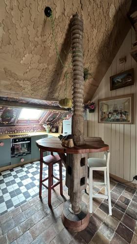 a kitchen with a table and chairs in a room at AU LIT ON DORT - Logis de Village in Bellême