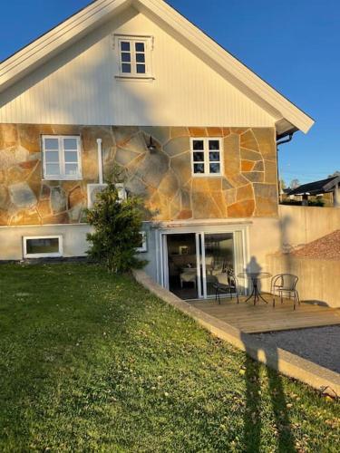 a stone house with a table and chairs in front of it at Villa Valberg in Sarpsborg