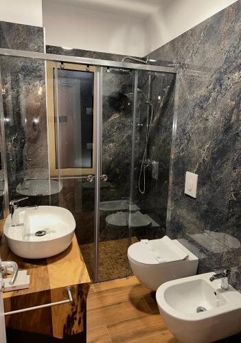a bathroom with two sinks and a shower at Class rooms Tirana in Tirana
