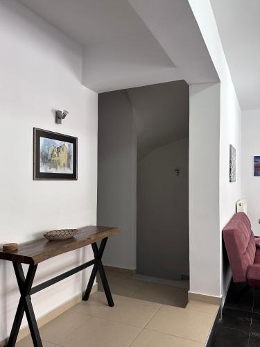 a living room with a table and a chair at Ammos Family Villa in Daratso