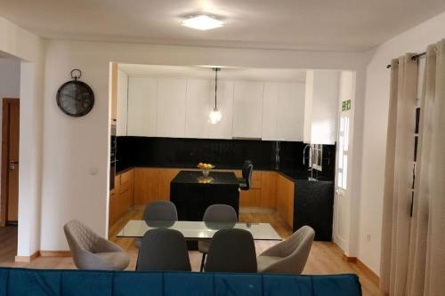 a living room with a table and some chairs at Casa Neto Jardim in Calheta