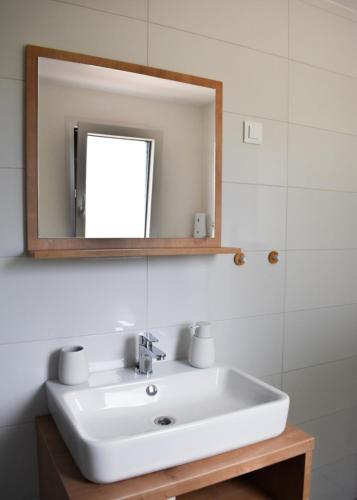 a bathroom with a white sink and a mirror at Luxury mobile home INES in Drage