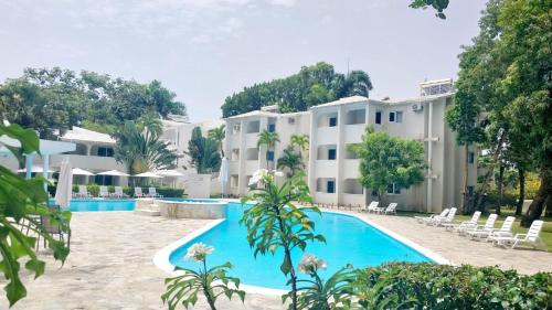 an exterior view of a hotel with a swimming pool at Tropical Casa Laguna in Cabarete