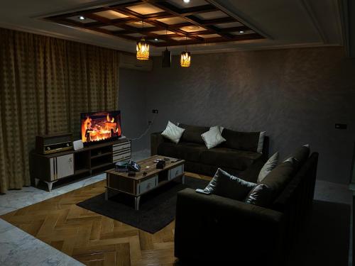 a living room with a couch and a tv at Villa cedra centre ville ifrane zéro six soixante-neuf soixante-huit 3828 in Ifrane