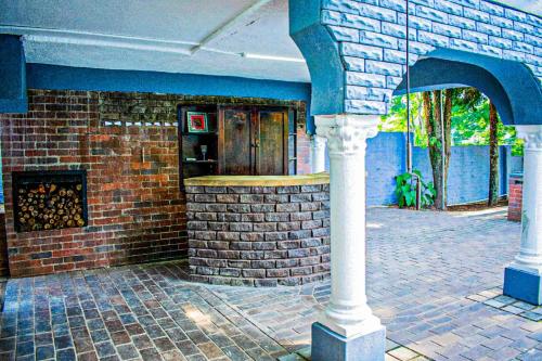 a brick building with a bar in front of it at 1 Bedroom Apartment Oak Park Stays in Pietermaritzburg