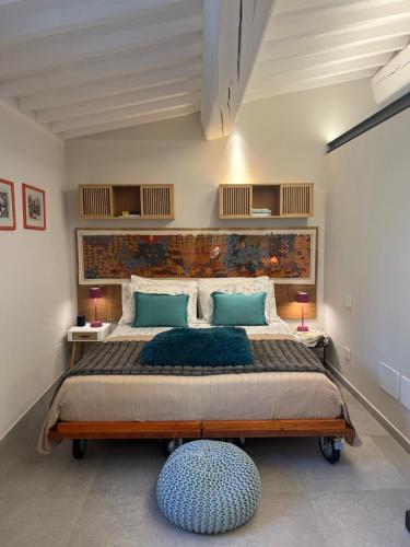 a bedroom with a large bed with blue pillows at Joy home in Antella
