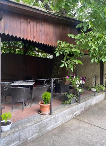 a patio with a table and chairs and plants at Penzión Bojnice in Bojnice