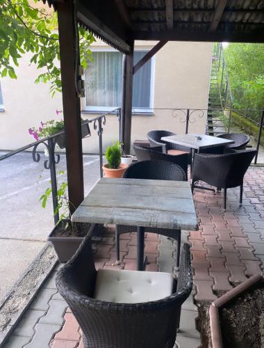 a table and chairs on a patio with tables and chairs at Penzión Bojnice in Bojnice