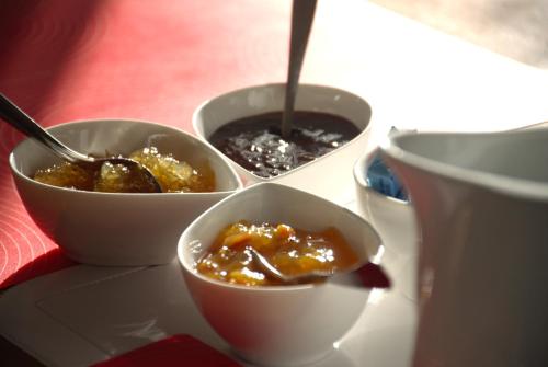 three bowls of food on a table with a drink at Villa Prato Agriturismo in Sperlonga