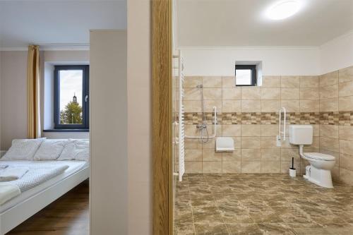 a bathroom with a bed and a shower and a toilet at Silver Cottage in Máriapócs
