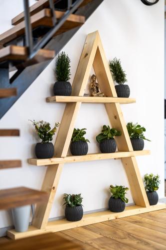 a wooden shelf with potted plants on it at The Bear Chalet with Private Hot Tub in Buşteni