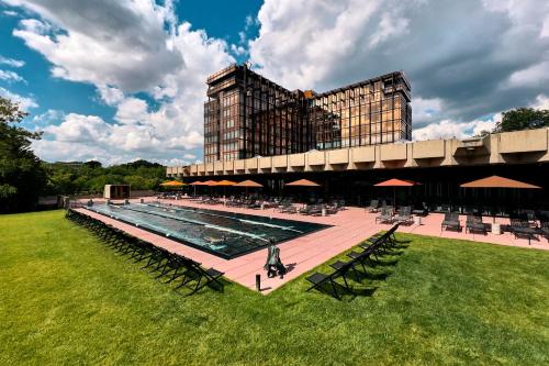 a large building with a swimming pool in front of a building at Mix Brussels --Gym & Wellness for adults only-- in Brussels