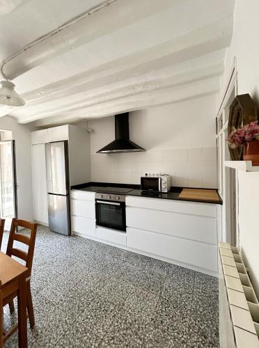 a kitchen with white cabinets and a stove at Enara-enea in Morentin