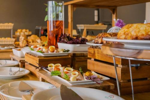 a buffet with plates of food on a table at Hotel Caribe by Faranda Grand, a member of Radisson Individuals in Cartagena de Indias
