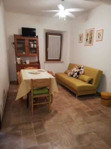 a living room with a couch and a table at La casina in Caprarola