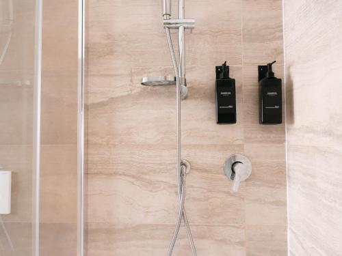 a shower in a bathroom with a glass door at Lake View Levico in Levico Terme