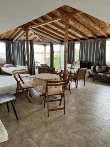 a living room with tables and chairs and a couch at obzor, orkinos in Obzor