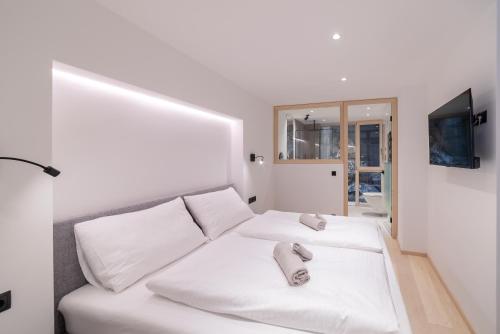 a white room with two white pillows on a couch at Rock Salzburg in Salzburg