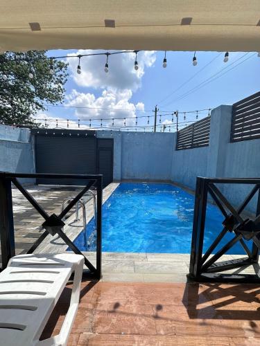 a swimming pool with a white bench next to a building at Aframezing Gabala in Gabala