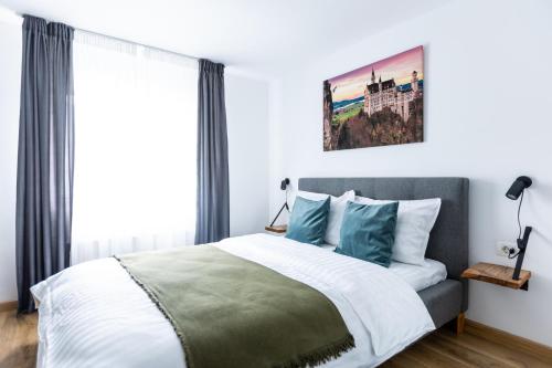 a bedroom with a large bed with blue pillows at The Bear House in Buşteni